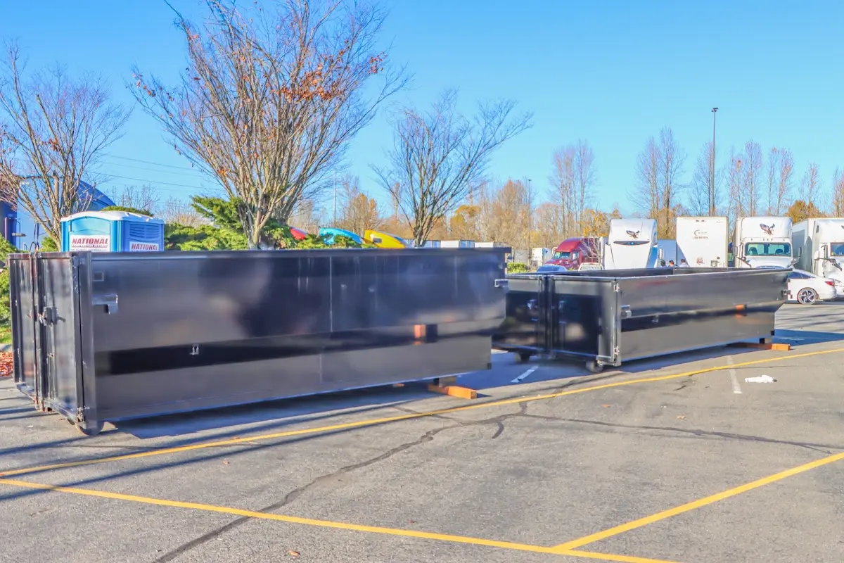 Professional dumpster rental service with roll-off container on residential driveway in Breitung